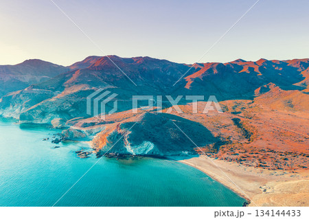 Aerial view of Rocky seashore with clear blue sky. Seascape in the evening. Cabo de Gata-Nijar reserve. Almeria Andalusia Spain 134144433