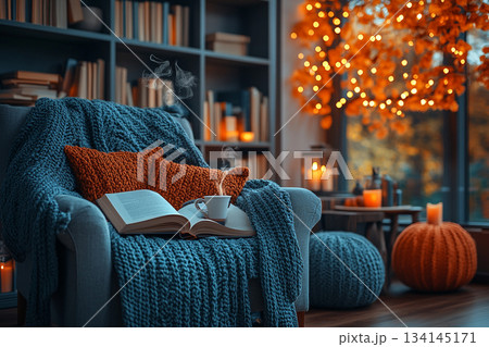 This image captures a cozy reading nook beside a rain-streaked window, perfect for relaxation on a rainy day. 134145171