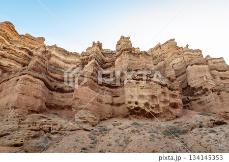 Close-up of layered rock formations with eroded shapes - wild nature and geology Close-up of layered rock formations with eroded shapes - wild nature and geology 134145353