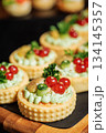 Savory tartlets with creamy filling and vibrant toppings 134145357