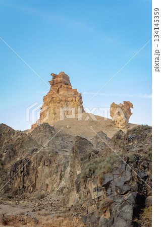 Wide shot of rock towers in desert under clear blue sky - wild nature landscape Wide shot of rock towers in desert under clear blue sky - wild nature landscape 134145359
