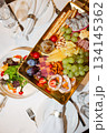 Top view of golden tray with cheese, fruit and appetizer assortment - luxurious buffet 134145362