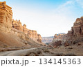 Wide shot of canyon with dusty road between rocky walls - wild nature landscape. 134145363