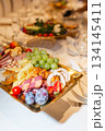Close-up of golden tray with cheese, fruit and appetizer assortment - luxurious buffet 134145411