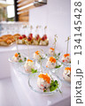 Top view of canapes with red caviar in glass dishes on white background. elegant buffet presentation 134145428
