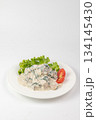 Close-up of chicken in creamy sauce with spinach and mushrooms on white background - appetizing dish 134145430