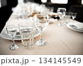 Restaurant. A table set for dinner. Cutlery, glasses and napkins on a table covered with a white tablecloth 134145549