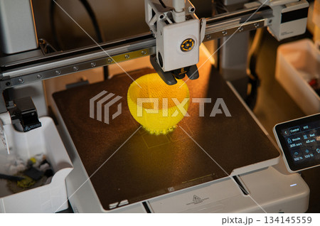 A student man print prototype on 3D printer 134145559