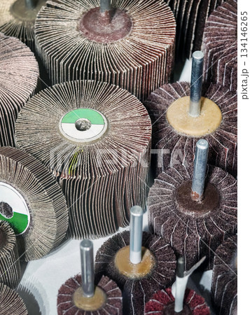 Tools for grinding and polishing arranged on a workbench in a workshop setting Tools for grinding and polishing arranged on a workbench in a workshop setting 134146265