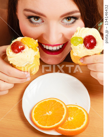 Woman taking delicious sweet cake. Gluttony. 134146432