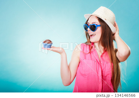Smiling summer woman holds cake in hand Smiling summer woman holds cake in hand 134146566