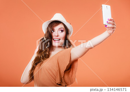 Woman taking self picture with smartphone camera Woman taking self picture with smartphone camera 134146571