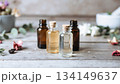 エッセンシャルオイル瓶とボタニカル素材／ラスティック木背景・アロマ・自然光 134149637