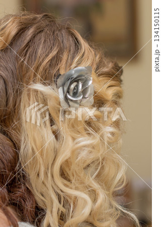 Blonde bride showing silver rose hair clip on wavy hair Blonde bride showing silver rose hair clip on wavy hair 134150115