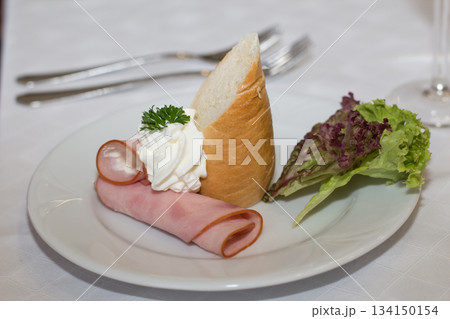 Wedding appetizer with ham, bread, cream and lettuce on white plate Wedding appetizer with ham, bread, cream and lettuce on white plate 134150154