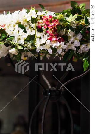 Wedding flower arrangement hanging on a metal stand Wedding flower arrangement hanging on a metal stand 134150174