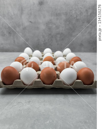 Brown and white eggs forming a checkerboard pattern in carton easter Brown and white eggs forming a checkerboard pattern in carton easter 134150276