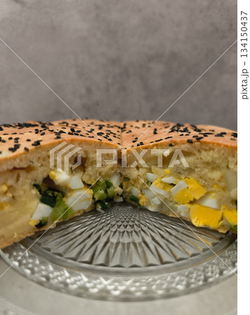 Traditional easter savory pie with eggs and spring onions filling copy space gray background Traditional easter savory pie with eggs and spring onions filling copy space gray background 134150437
