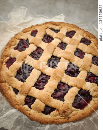Freshly baked cherry pie sits on baking paper, ready for a valentine's day breakfast treat in prague 134150622
