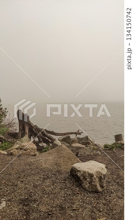 Fog rolling into strbske pleso lake in the high tatras mountains Fog rolling into strbske pleso lake in the high tatras mountains 134150742