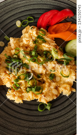 Scrambled eggs with spring onions and vegetables on a dark plate strbske pleso, high tatras 134150745
