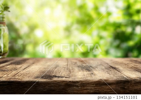 Radiant green spring background panorama with wooden table for a concept 134151101