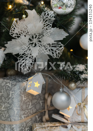 White, silver and gold gift boxes under Christmas tree with white decoration. New Year, Christmas background. Christmas tree, boxes with gifts,Christmas decor 134151240