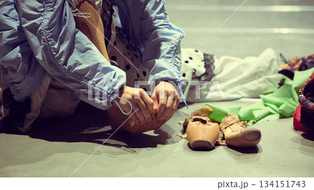 Dancer adjusting shoes on floor as part of stage preparation ritual Dancer adjusting shoes on floor as part of stage preparation ritual 134151743