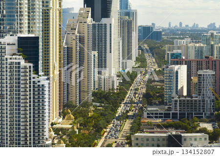 View from above of luxurious highrise hotels and condos on Atlantic ocean shore in Sunny Isles Beach city. Urban street with busy traffic. American tourism infrastructure in southern Florida 134152807