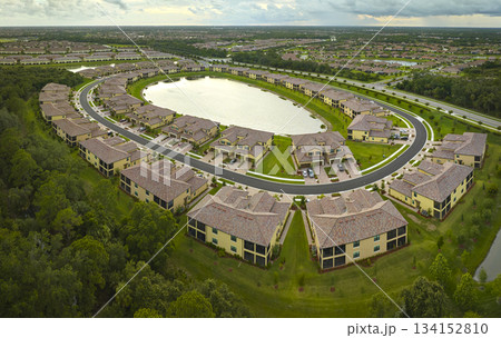 View from above of densely built residential houses near retention ponds in closed living clubs in south Florida. American dream homes as example of real estate development in US suburbs 134152810