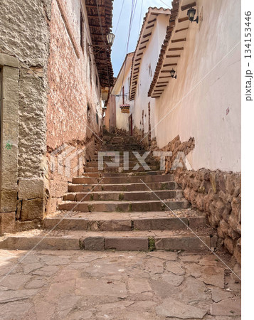 A narrow alleyway with a stone staircase leading up to a building. Chinchero, Cusco A narrow alleyway with a stone staircase leading up to a building. Chinchero, Cusco 134153446
