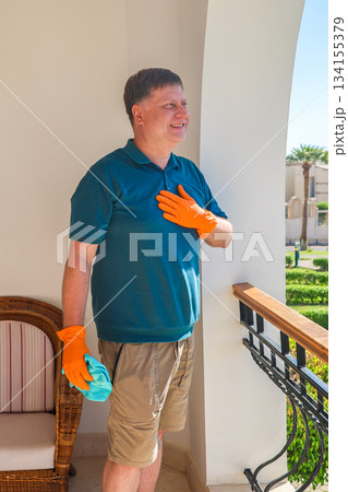 Happy Man on His Balcony Joyfully Greeting Neighbors, Embracing Community Spirit and Connection in a Bright, Welcoming Home Environment 134155379