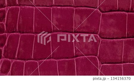 Close-up of luxurious lava red crocodile leather texture with bold rectangular embossing and glossy finish. Natural background for fashion design, material texture, color trend backdrop Close-up of luxurious lava red crocodile leather texture with bold rectangular embossing and glossy finish. Natural background for fashion design, material texture, color trend backdrop 134156370