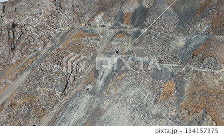 Aerial view of rocky terrain with mining roads and mineral deposits 134157375