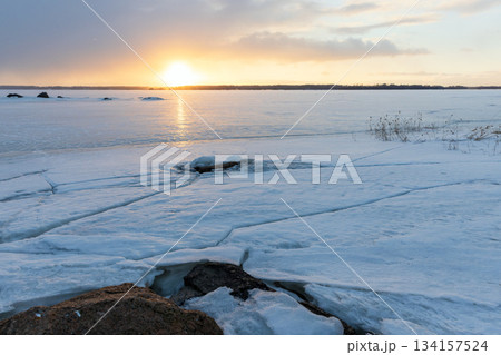 Coastal granite rocks are covered with ice and snow. Winter landscape 134157524