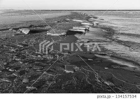 Black and white landscape photography featuring ice floes mixed with sand Black and white landscape photography featuring ice floes mixed with sand 134157534