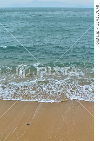 Close-up of soft waves sand beach and blue sea. Texture of water, white foam waves. Seascape, Sea background, Sea water with copy space, summer vacation concept.  134157649
