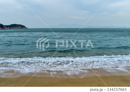 Close-up of soft waves sand beach and blue sea. Texture of water, white foam waves. Seascape, Sea background, Sea water with copy space, summer vacation concept. Close-up of soft waves sand beach and blue sea. Texture of water, white foam waves. Seascape, Sea background, Sea water with copy space, summer vacation concept. 134157665
