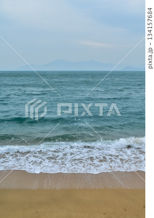 Close-up of soft waves sand beach and blue sea. Texture of water, white foam waves. Seascape, Sea background, Sea water with copy space, summer vacation concept.  134157684