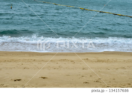 Close-up of soft waves sand beach and blue sea. Texture of water, white foam waves. Seascape, Sea background, Sea water with copy space, summer vacation concept. Close-up of soft waves sand beach and blue sea. Texture of water, white foam waves. Seascape, Sea background, Sea water with copy space, summer vacation concept. 134157686