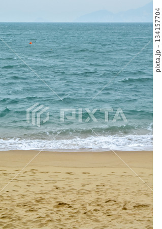 Close-up of soft waves sand beach and blue sea. Texture of water, white foam waves. Seascape, Sea background, Sea water with copy space, summer vacation concept.  134157704