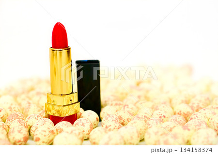 Make up.Red pink cosmetic lipstick on spoted pebbles stones 134158374