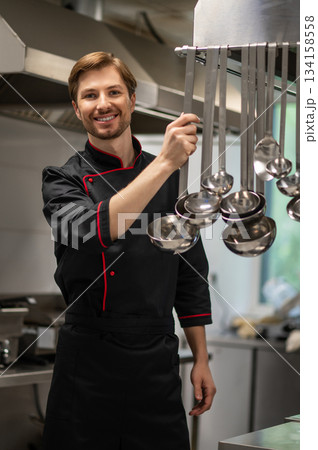 Confident male chef working in restaurant kitchen 134158558