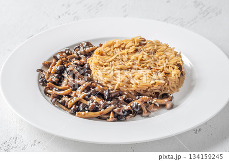 Savory fried rice topped with umami Shimeji mushrooms and golden sunny egg 134159245