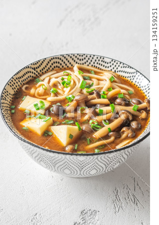 Japanese udon soup with Shimeji mushrooms, tofu, and rich dark umami broth Japanese udon soup with Shimeji mushrooms, tofu, and rich dark umami broth 134159251
