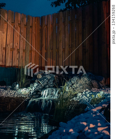 An alpine slide on the terrace of a country house. Nearby is a pond and a wooden fence. An alpine slide on the terrace of a country house. Nearby is a pond and a wooden fence. 134159268