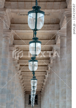 Corridor perspective with Columns and Antique lantern hanging from Ceiling inside of the Courtyard of the Honor gallery. Corridor perspective with Columns and Antique lantern hanging from Ceiling inside of the Courtyard of the Honor gallery. 134159587