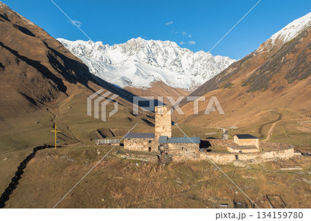 medieval Georgian church on the background of the peak of Shkhara 134159780