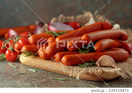 Thin smoked sausages with tomatoes, onion, garlic, and rosemary. 134159973