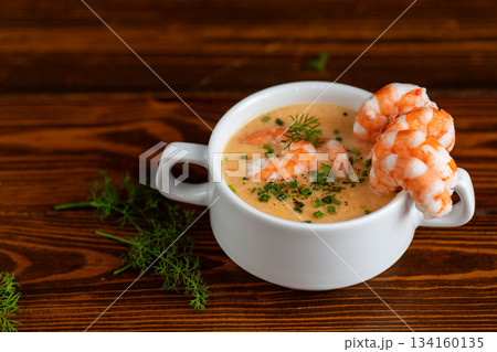 Delicious creamy shrimp bisque presented in white ceramic cup Delicious creamy shrimp bisque presented in white ceramic cup 134160135